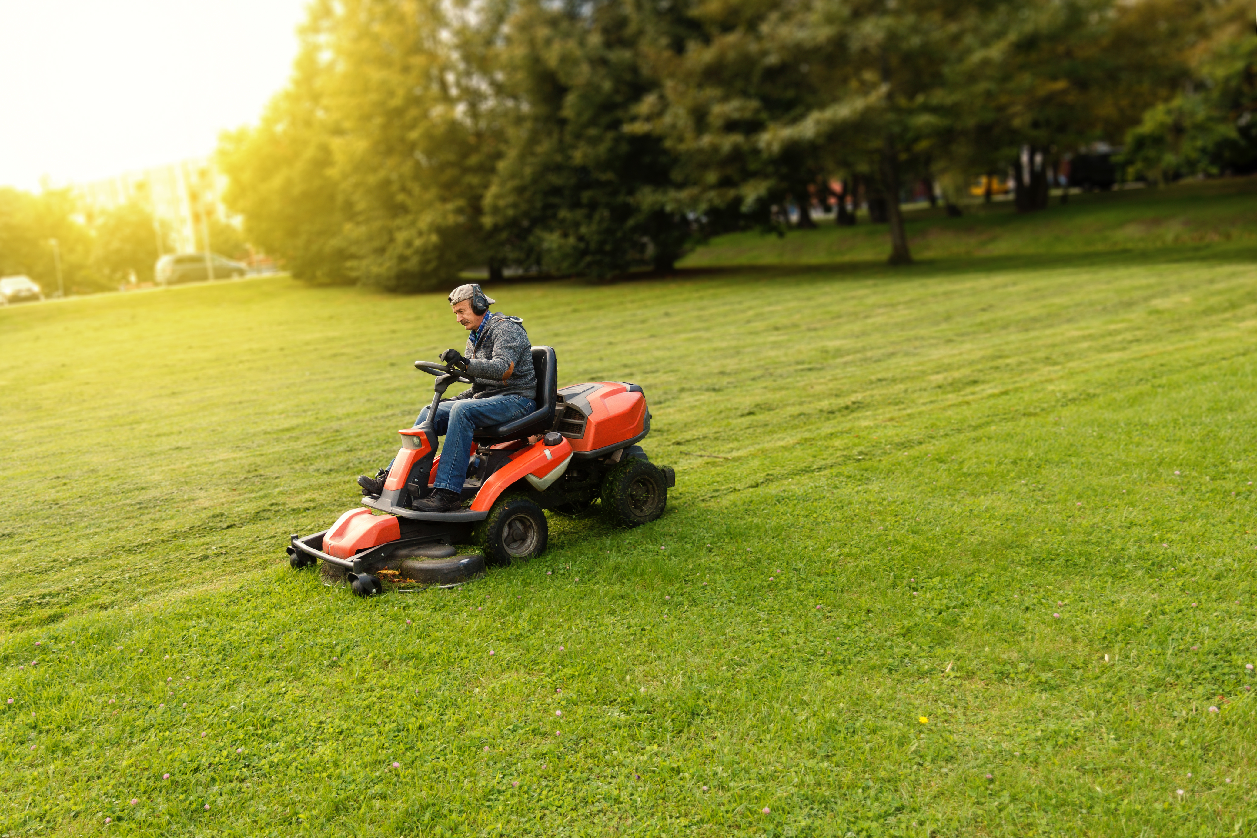 Landscaper mowing grass