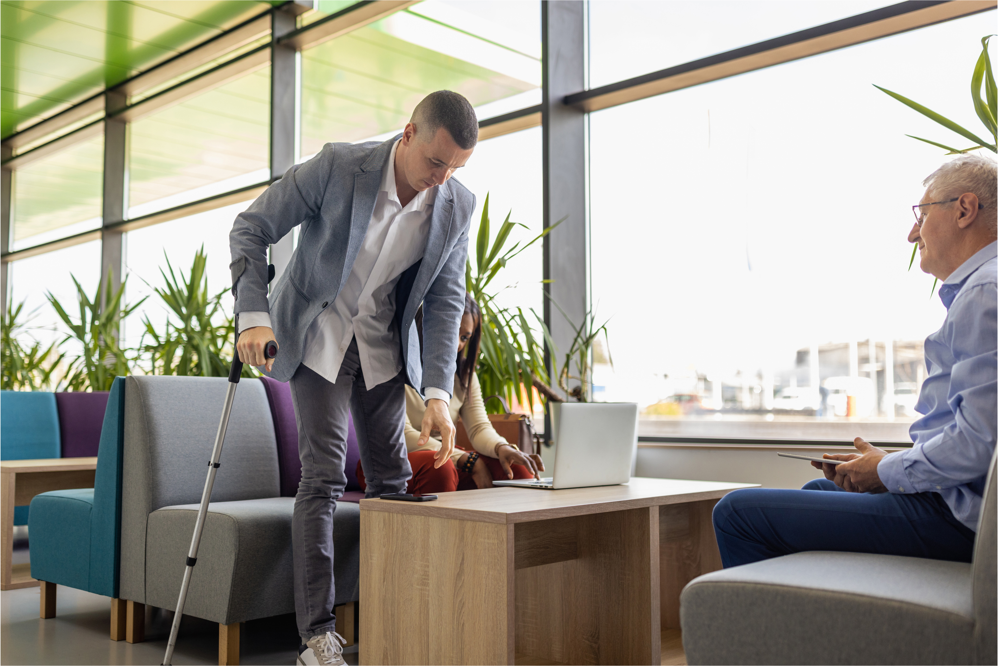 Man getting up from chair using a cane